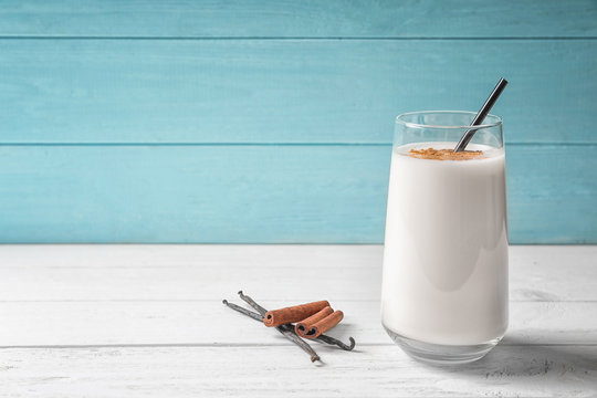 Vanilla and cinnamon protein shake in glass on table