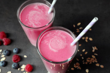 Glasses with berry protein shakes on table, closeup