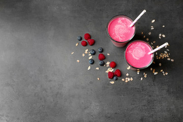 Glasses with berry protein shakes on table