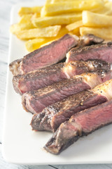 Beef steak with fried potatoes on the plate