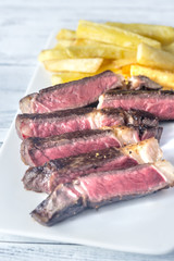 Beef steak with fried potatoes on the plate