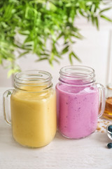 Jars with different protein shakes on table