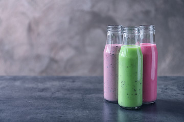 Bottles with different protein shakes on table