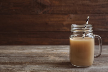 Jar with tasty protein shake on wooden table