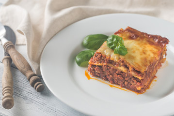Portion of lasagne on the wooden table
