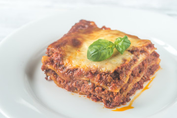 Portion of lasagne on the wooden table