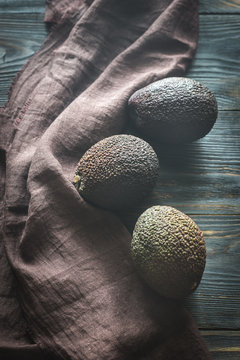 Hass avocados on the wooden background