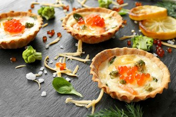 Tasty salmon tartlets on table, closeup