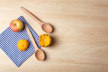 Composition with towel and kitchen utensils on wooden background