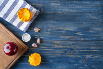 Composition with towel and cutting board on wooden background