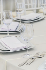 Beautifully decorated table for a celebration in a restaurant in white colors.