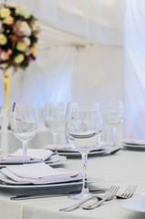 Beautifully decorated table for a celebration in a restaurant in white colors.