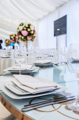 Beautifully decorated table for a celebration in a restaurant in white colors.