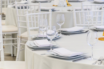 Beautifully decorated table for a celebration in a restaurant in white colors.