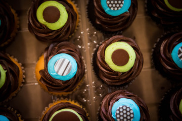 Top down shot of colorful blue and yellow chocolate cupcakes.