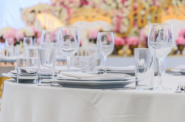 Beautifully decorated table for a celebration in a restaurant in white colors.