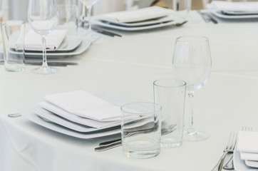 Beautifully decorated table for a celebration in a restaurant in white colors.