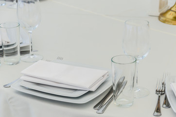 Beautifully decorated table for a celebration in a restaurant in white colors.