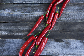 Top View Pile of Fresh Red Hot Chili on blue wooden background. Texture or template to mock up or...