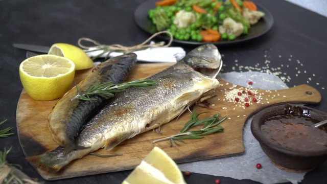 A beautiful fish dish with vegetables and greens around