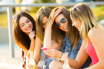 Friends have fun together and drink cocktails on the street