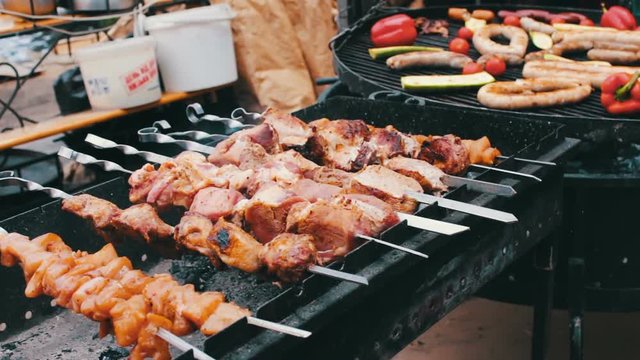 Tasty fresh meat strung on a skewer is fried on brazier. Shish kebab from pork and vegetables