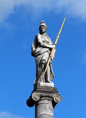 An old sculpture of white marble in the city park.  City park sculpture