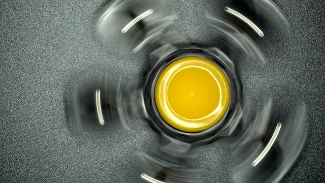 The spinner spinning and move slowly on a black background. This is macro shot on a slider.