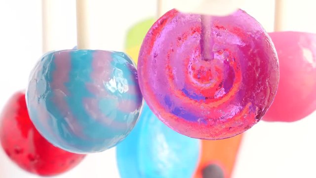 colorful lollipops hang in the air. 4k slow motion