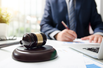 Wooden gavel on table. Attorney working in courtroom.