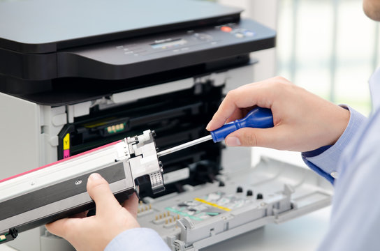 Man repairing toner for laser printer