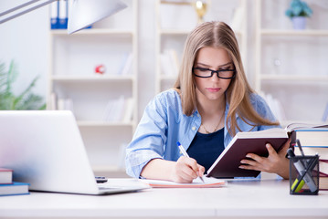 Young teenage female student preparing for exams at home