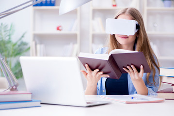 Young female student preparing for exams with VR glasses