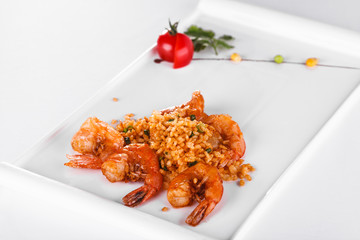 Prawns served with the rice on a white plate, chinese food