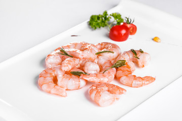 Roasted prawns on white plate on white background
