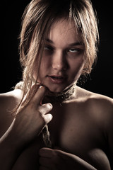 young woman with tied neck on black background choke