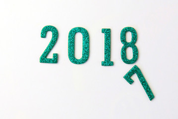 2018 New year concept. Group of businessman and business woman miniature figures sitting on 2 0 1 8 number wooden block toy on world map.