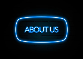 About Us  - colorful Neon Sign on brickwall