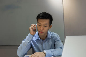 Businessman answer the phone in office