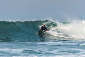 Fototapeta na wymiar Bodyboarder surfing ocean wave