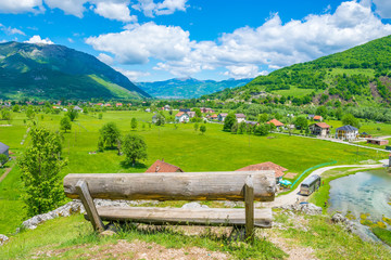 A lone wooden bench stands on top of a mountain.