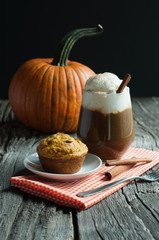 Pumpkin latte with spices, coffee autumn of fall drink, muffin, healthy snack Thanksgiving table, copy space, selective focus