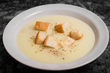 Mushroom cream soup with croutons and spices on a plate
