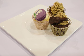 various cupcakes: vanilla, chocolate,  in decorative cups