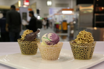  cupcakes: vanilla, chocolate,coffee in decorative cups