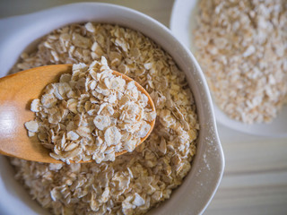 The oats rice in white bowl on top table wood worm tone image