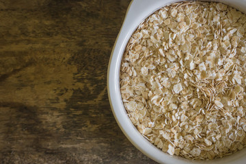The oats rice in white bowl on top table wood worm tone image