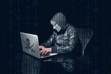 Masking anonymous hacking and using computer to hack passwords. Side perspective