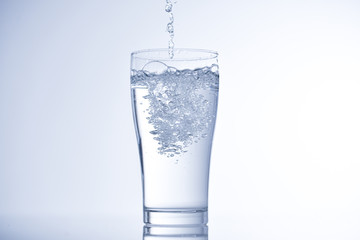 pouring water into glass