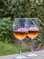 Glasses of rosé with floating pink flowers